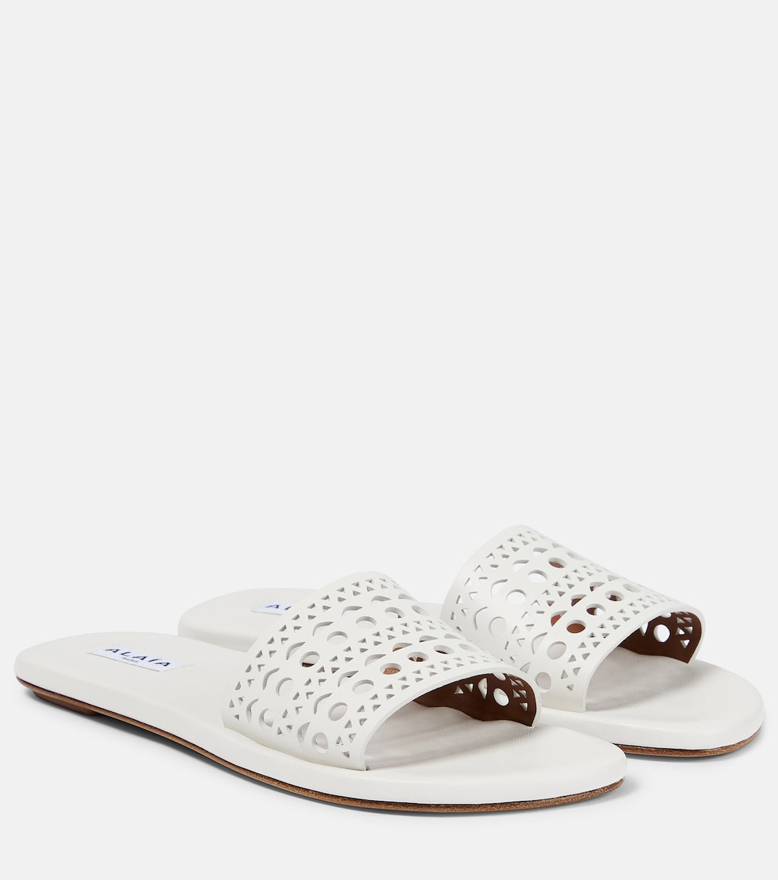 Alaïa laser cut leather mules, white